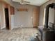 Living room with wood-look floors, wood burning stove, and ceiling fan at 4726 E 210 N, Lebanon, IN 46052