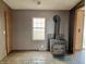 Living room with wood-look floors, wood burning stove, and window at 4726 E 210 N, Lebanon, IN 46052