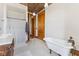 Elegant bathroom with clawfoot tub, tile floor, and ornate wood accents at 7955 W 400 N, Boggstown, IN 46110