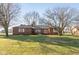 Brick ranch house with large yard and mature trees at 1028 S Country Ln, Greenfield, IN 46140