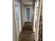 Hallway with hardwood floors and bedroom access at 1028 S Country Ln, Greenfield, IN 46140