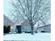 Brick home with snowy front yard and tree at 13645 Seven Oaks Dr, Fishers, IN 46038