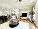 Open concept living area with hardwood floors and large TV at 13645 Seven Oaks Dr, Fishers, IN 46038