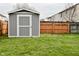 Gray shed with white trim in backyard, next to wooden fence at 139 Fountain Dr, Mooresville, IN 46158