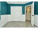 Teal and white bedroom with double doors and wood-look floors at 139 Fountain Dr, Mooresville, IN 46158