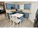 Modern kitchen featuring blue cabinets and a breakfast bar at 139 Fountain Dr, Mooresville, IN 46158