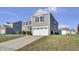 Two-story gray house with white garage door and landscaping at 2034 Buckthorn Dr, Columbus, IN 47201