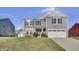 Two-story gray house with white garage door and landscaping at 2034 Buckthorn Dr, Columbus, IN 47201