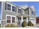 Two-story gray house with white garage door and landscaping at 2034 Buckthorn Dr, Columbus, IN 47201
