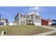 Two-story gray house with white garage door and landscaping at 2034 Buckthorn Dr, Columbus, IN 47201