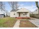 Beige house with red steps, front yard, and satellite dish at 3322 W 22Nd St, Indianapolis, IN 46222