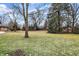 Large backyard with mature trees and grassy area at 4621 N Meridian St, Indianapolis, IN 46208
