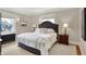 Bright bedroom with a king-size bed, hardwood floors, and large windows at 4621 N Meridian St, Indianapolis, IN 46208