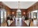 Formal dining room with wood paneling, large windows, and a beautiful chandelier at 4621 N Meridian St, Indianapolis, IN 46208