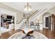 Bright and spacious foyer with hardwood floors, a grand staircase, and elegant chandelier at 4621 N Meridian St, Indianapolis, IN 46208