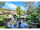Landscaped front yard with fountain, lush greenery, and circular driveway at 4621 N Meridian St, Indianapolis, IN 46208