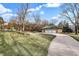 Brick detached garage with three garage doors and a curved driveway at 4621 N Meridian St, Indianapolis, IN 46208