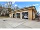 Three-car detached garage with white doors, open and showing interior at 4621 N Meridian St, Indianapolis, IN 46208