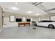 Modern three-car garage with epoxy floor, and a bench at 4621 N Meridian St, Indianapolis, IN 46208