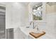 White kitchen with farmhouse sink, marble countertops, and ample cabinet storage at 4621 N Meridian St, Indianapolis, IN 46208