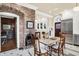Eat-in kitchen with brick fireplace, stainless steel appliances, and white cabinetry at 4621 N Meridian St, Indianapolis, IN 46208