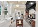 Modern kitchen with white cabinets, stainless steel appliances, and exposed brick at 4621 N Meridian St, Indianapolis, IN 46208