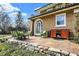 Stone patio with modern seating, a wooden cabinet, and a view of the surrounding greenery at 4621 N Meridian St, Indianapolis, IN 46208