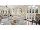Bright sunroom with arched windows, wicker furniture, and a glass-top coffee table at 4621 N Meridian St, Indianapolis, IN 46208