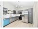 Modern gray kitchen with stainless steel appliances and a blue dishwasher at 6123 Boulder Dr, Anderson, IN 46013