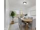 Dining room with large windows, hardwood floors, and a wood table with gray chairs at 8022 Buford St, Indianapolis, IN 46216