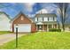 Brick and white two-story house with a two-car garage and manicured lawn at 8863 Gardenia Ct, Noblesville, IN 46060