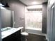 Modern bathroom with marble shower and dark vanity at 1314 Arrow Ave, Anderson, IN 46016