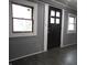 Dark grey walls, dark floors, and a dark brown door with windows at 1314 Arrow Ave, Anderson, IN 46016