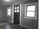 Dark grey walls, dark floors, and a dark brown door with windows at 1314 Arrow Ave, Anderson, IN 46016