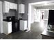 Updated kitchen with white cabinets and black appliances at 1314 Arrow Ave, Anderson, IN 46016