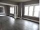 Spacious living room with grey walls, dark floors, and lots of natural light at 1314 Arrow Ave, Anderson, IN 46016