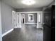 Open living room with grey walls, dark floors, and white columns at 1314 Arrow Ave, Anderson, IN 46016