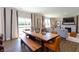 Bright dining area with a live-edge table and bench overlooking the backyard at 3255 Wetherby Pl, Danville, IN 46122