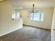 Bright dining room with a modern chandelier and view to backyard at 5549 S Emerson Ave, Indianapolis, IN 46237