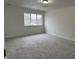 Bright bedroom with gray carpet and a window at 5845 Shipwatch Pl, Indianapolis, IN 46237