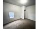 Simple carpeted bedroom with a closet and window at 2134 Pleasant St, Indianapolis, IN 46203