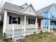 Charming one-story home with a front porch and red door at 2134 Pleasant St, Indianapolis, IN 46203