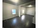 Bright living room with dark floors and access to other rooms at 2134 Pleasant St, Indianapolis, IN 46203