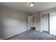 Well-lit bedroom with grey carpet and closet at 3411 N Richardt Ave, Indianapolis, IN 46226