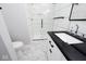 Stylish bathroom with a shower and black countertop at 5319 W 11Th St, Indianapolis, IN 46224