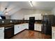 Modern kitchen with white shaker cabinets, wood countertops and black appliances at 6846 Westdrum Rd, Indianapolis, IN 46241