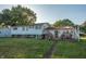 Home's back deck with patio furniture and landscaping at 801 Spring Valley Dr, Indianapolis, IN 46231