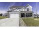 Two-story house with gray siding, brick accents, and a large front yard at 13178 N Departure W Blvd, Camby, IN 46113