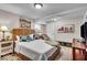 Basement bedroom with wicker bed, ample pillows, and nightstand at 2222 E 75Th St, Indianapolis, IN 46240