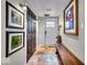 Basement entryway with wood bench, dark doors, and framed art at 2222 E 75Th St, Indianapolis, IN 46240